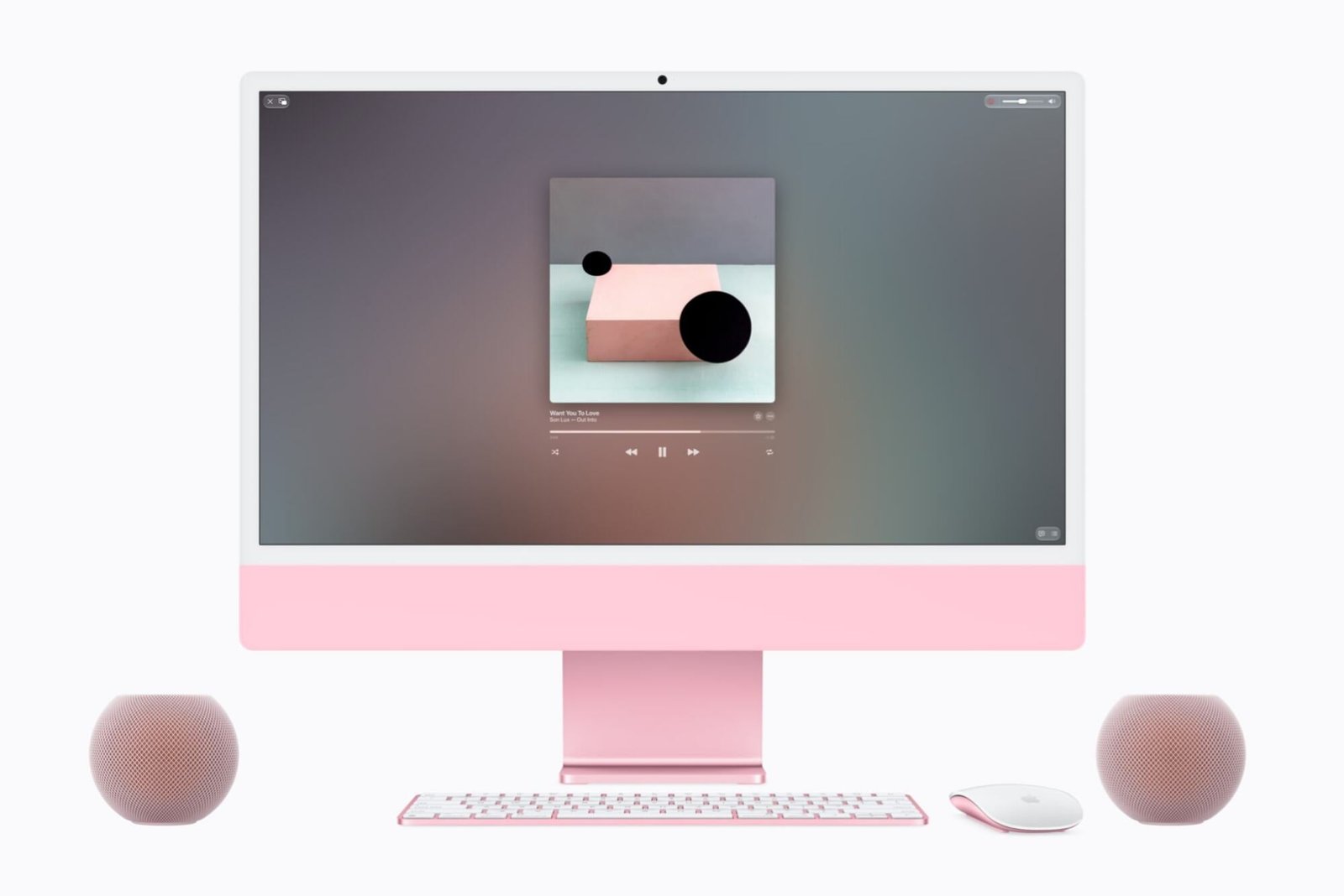 two homepod mini 2 speakers next to an imac